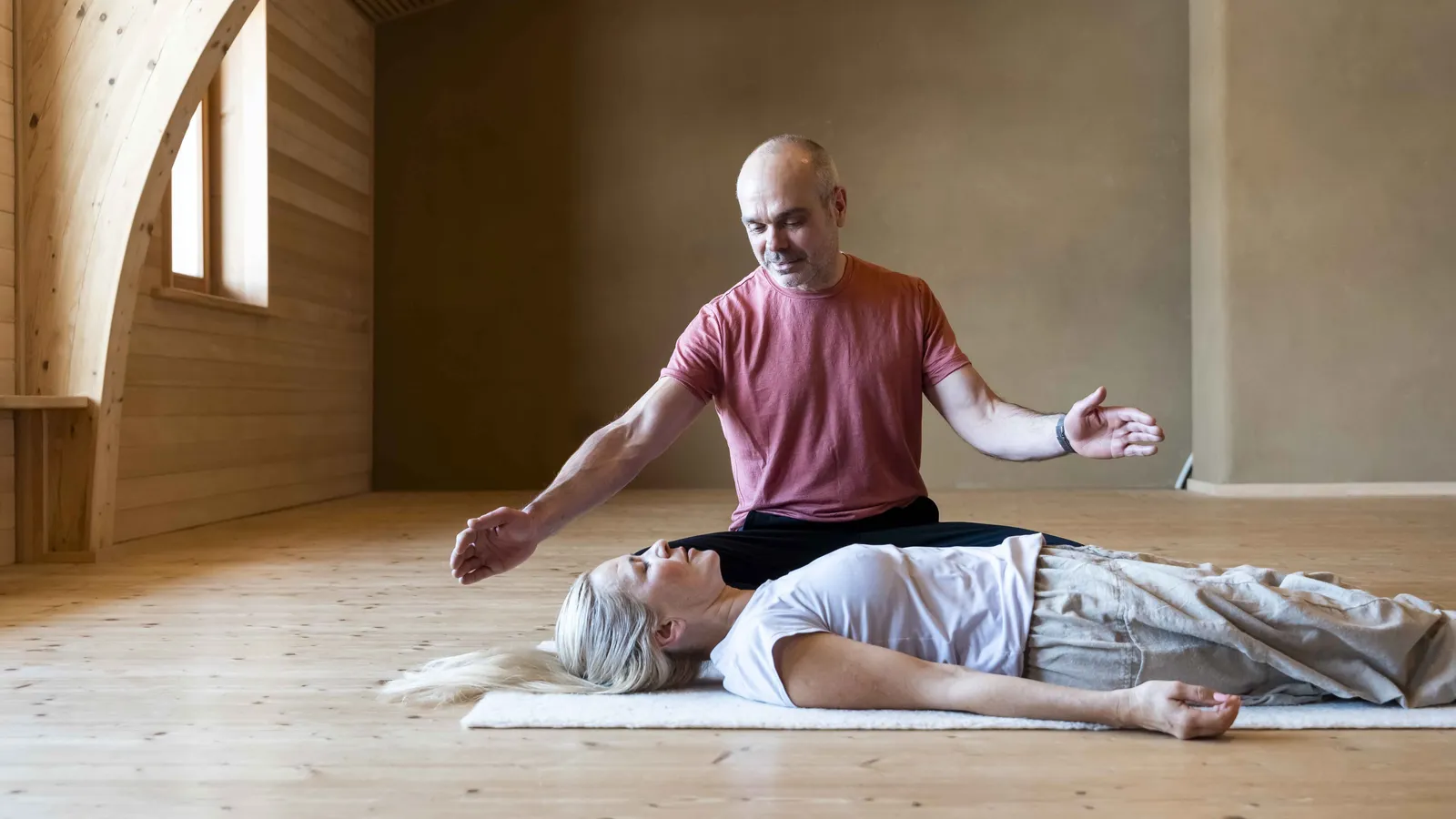 Breathwork-Session im menschen:raum – Robert Mittl hält den Raum für eine liegende Teilnehmerin